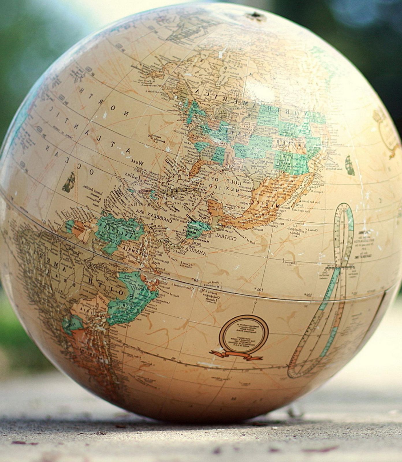A large antique globe resting on a path